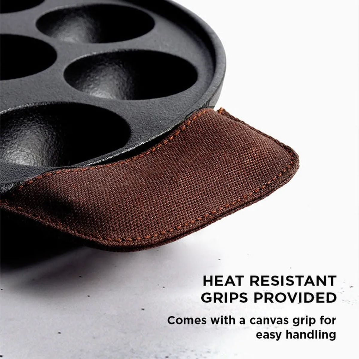 Close view of the pan handle with a brown heat-resistant grip