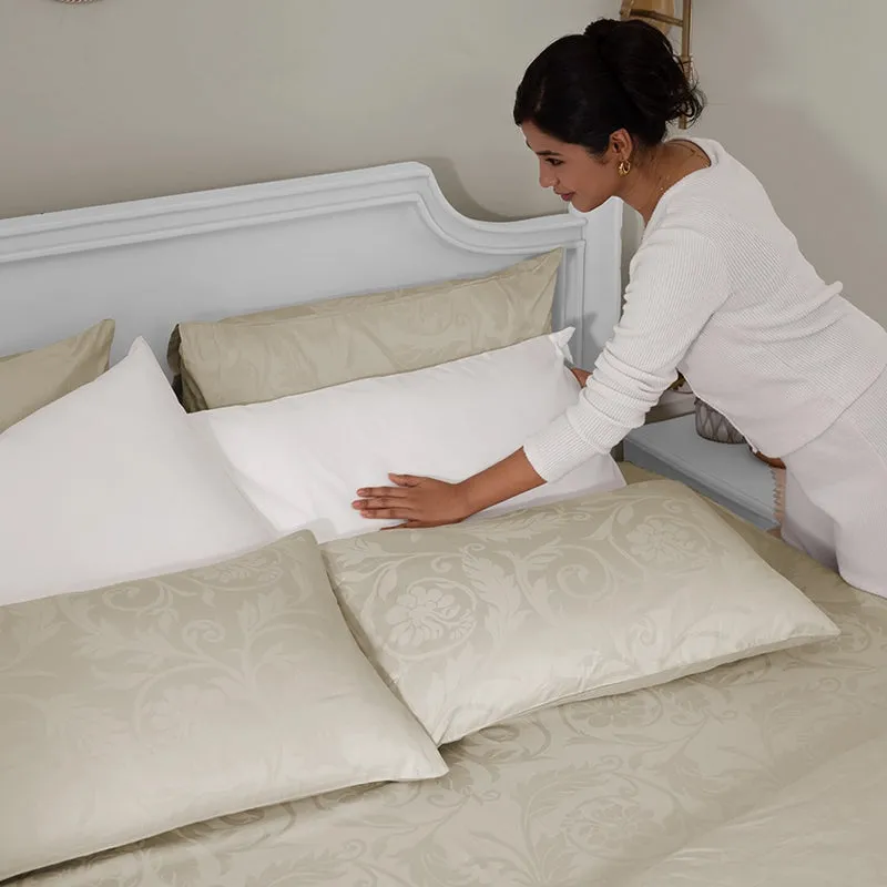 Beige floral bedsheet set styled on a bed with pillows