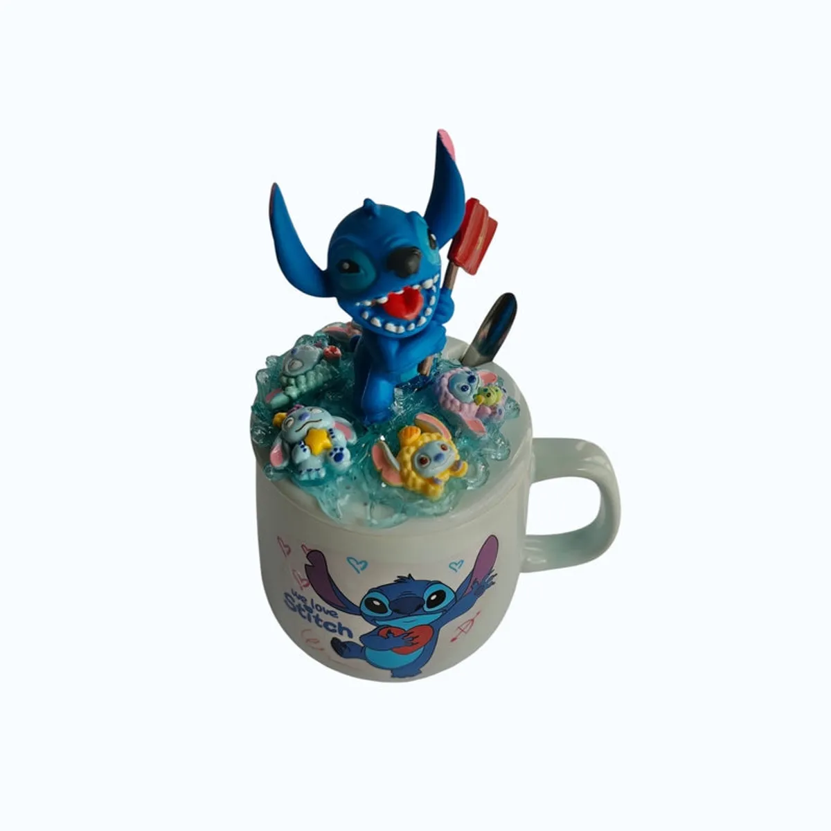 Front angled view of cartoon print mug with sculpted blue lid