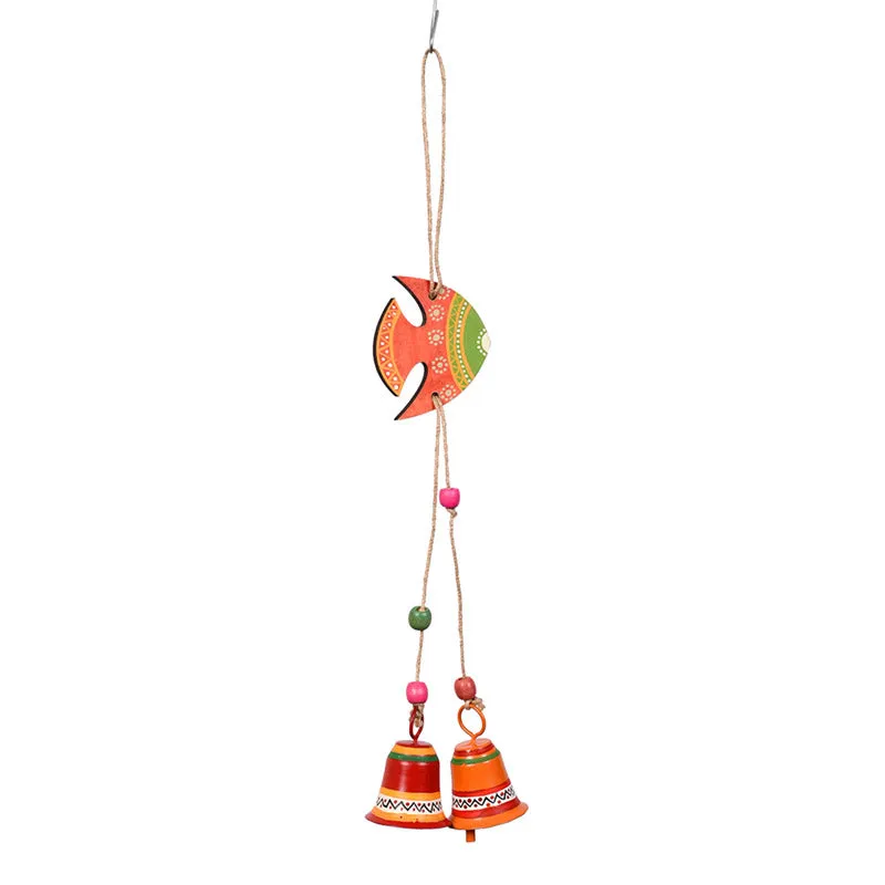 Orange and green fish-shaped windchime isolated on a white background.