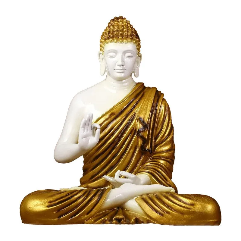 Front view of white and gold seated Buddha idol on a plain background