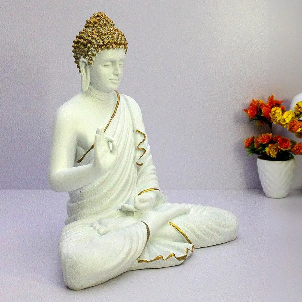 Angled view of white Buddha showpiece with gold detailing