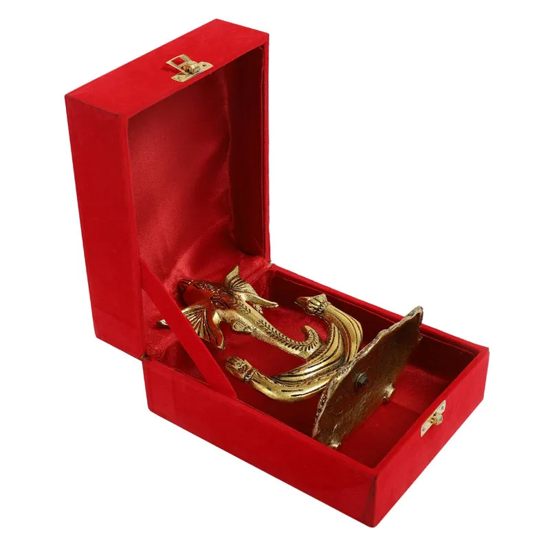 Side view of the gold-toned Vinakaya idol in a red gift box