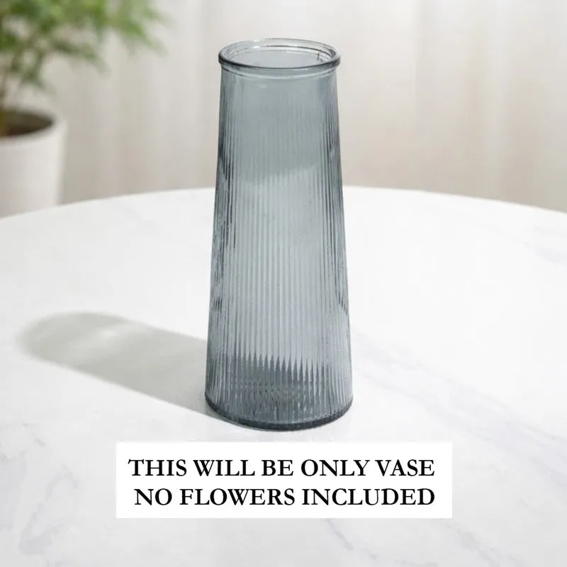 Empty grey fluted glass vase on a white tabletop