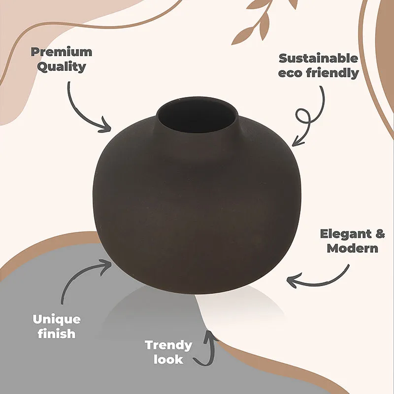 Black round metal vase with a matte textured finish
