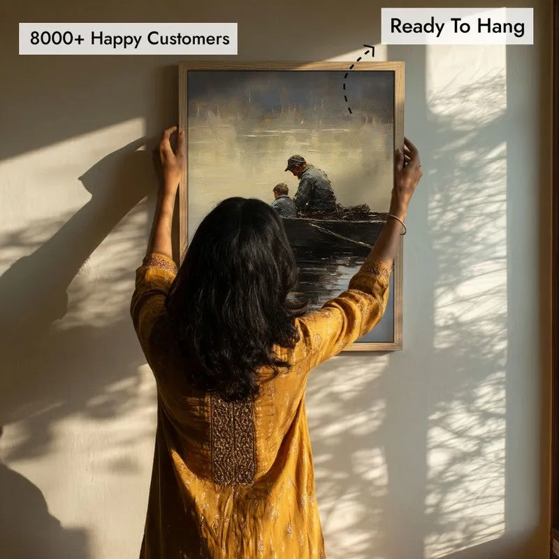 Person hanging the framed wall art on a wall