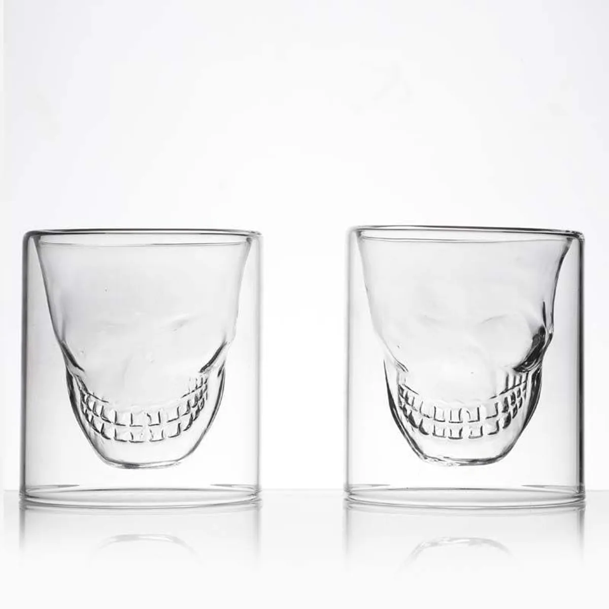 Two transparent skull-design shot glasses shown from the front.