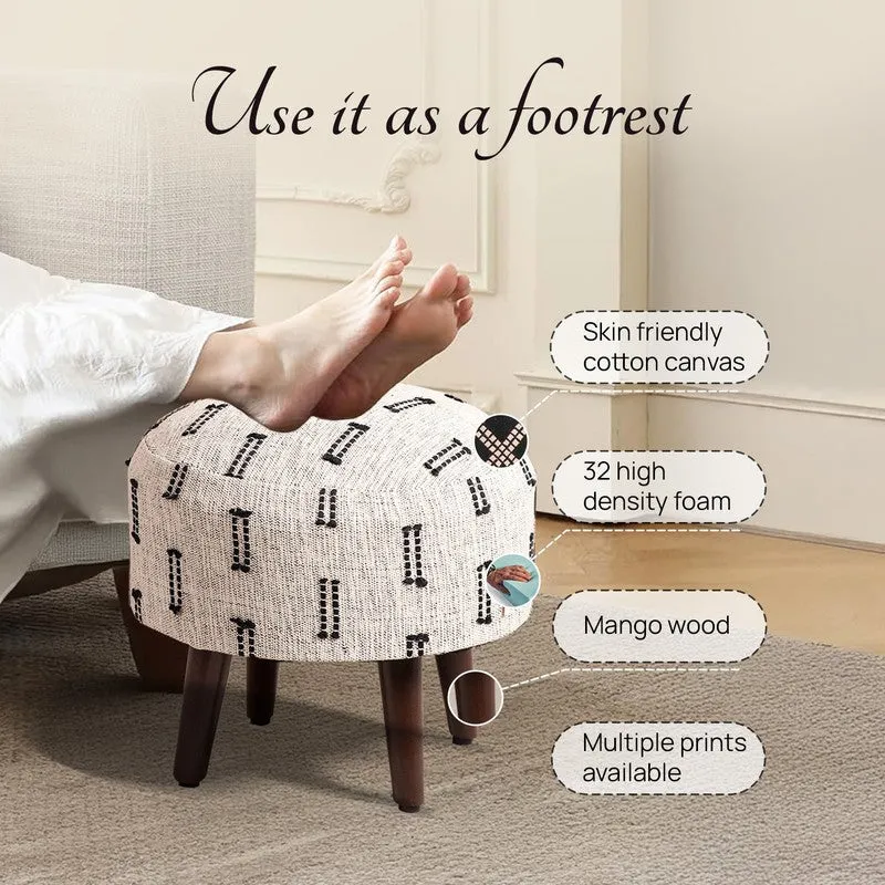Ottoman shown as a footrest with its cotton canvas cover and wooden legs