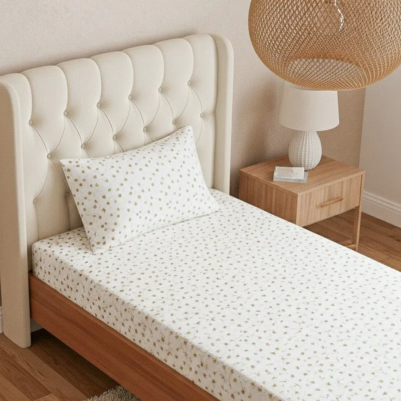 Close view of white bedsheet and pillow cover with small yellow floral print