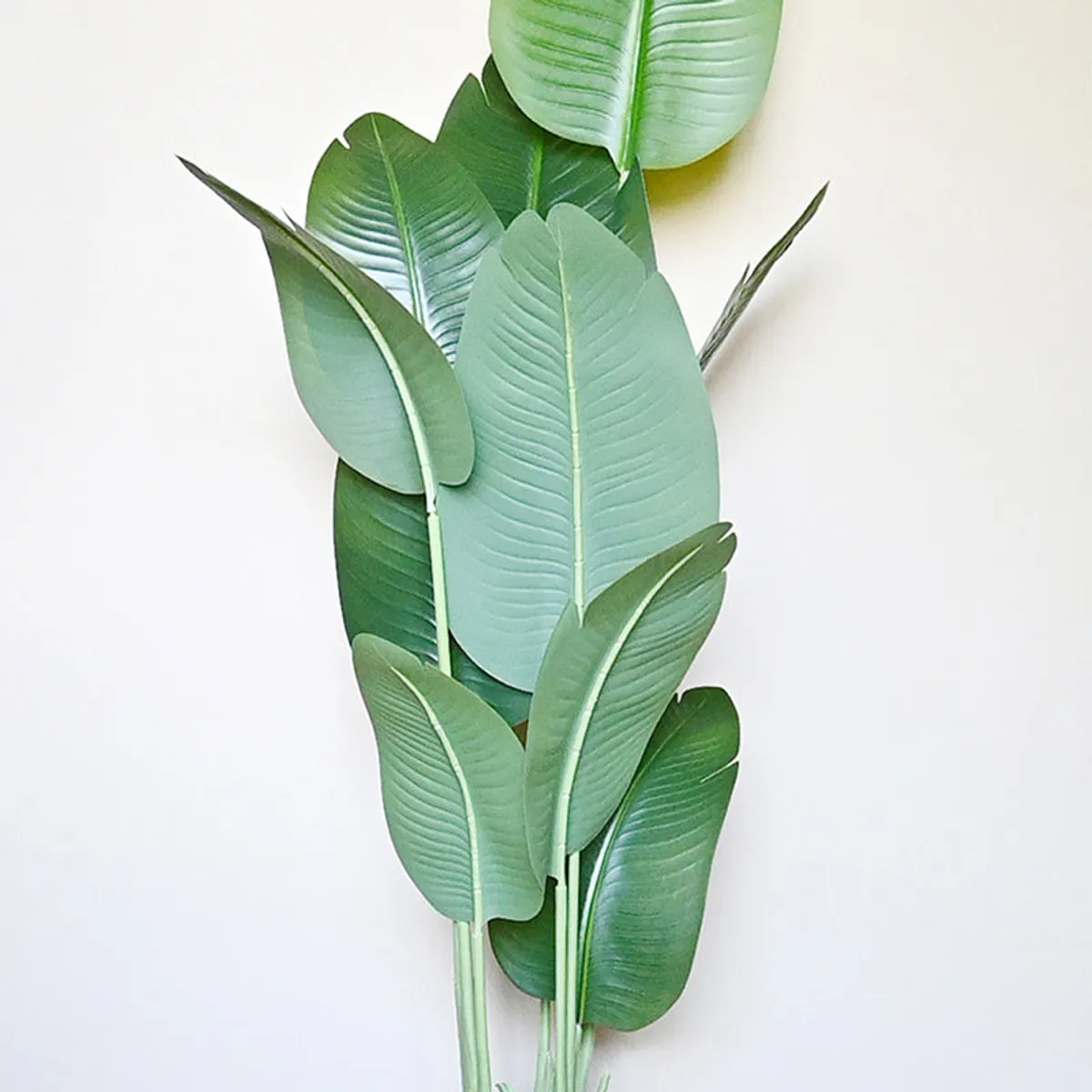 Close-up of layered green artificial leaves with raised vein details