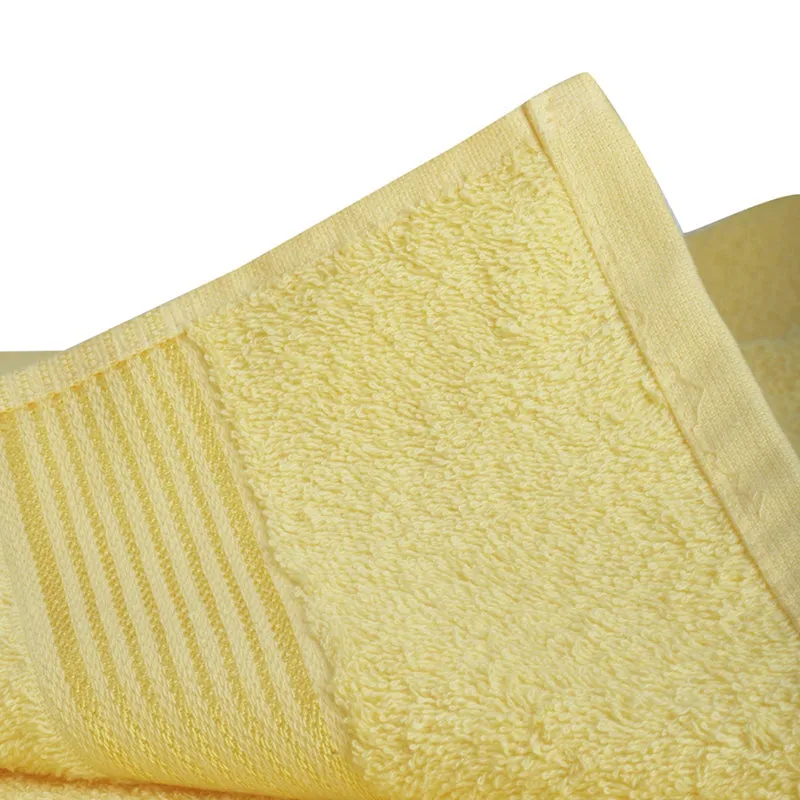 Yellow towel showing plush surface and striped border detail