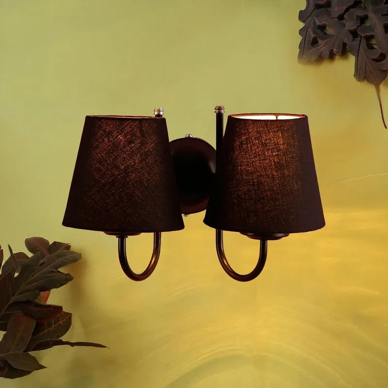 Black double wall lamp with softly glowing shades