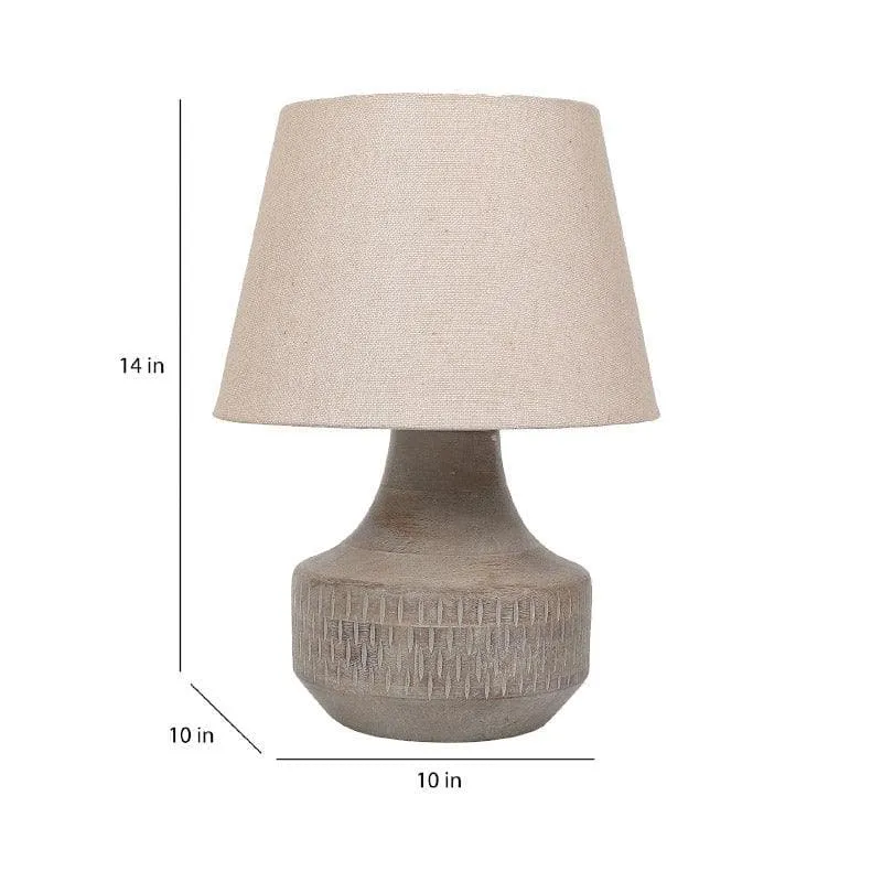 Beige table lamp with fabric shade and rounded textured base on white background.