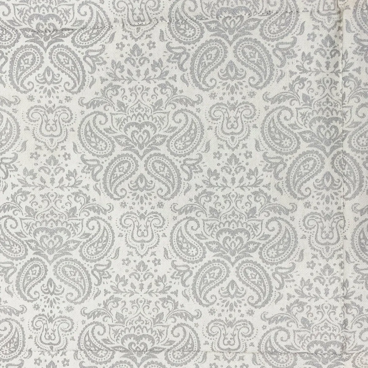 Close-up of grey paisley fabric on the basket exterior