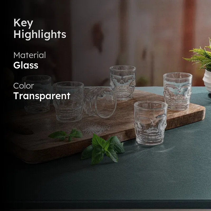 Clear skull-shaped shot glasses on a board with highlight text overlay