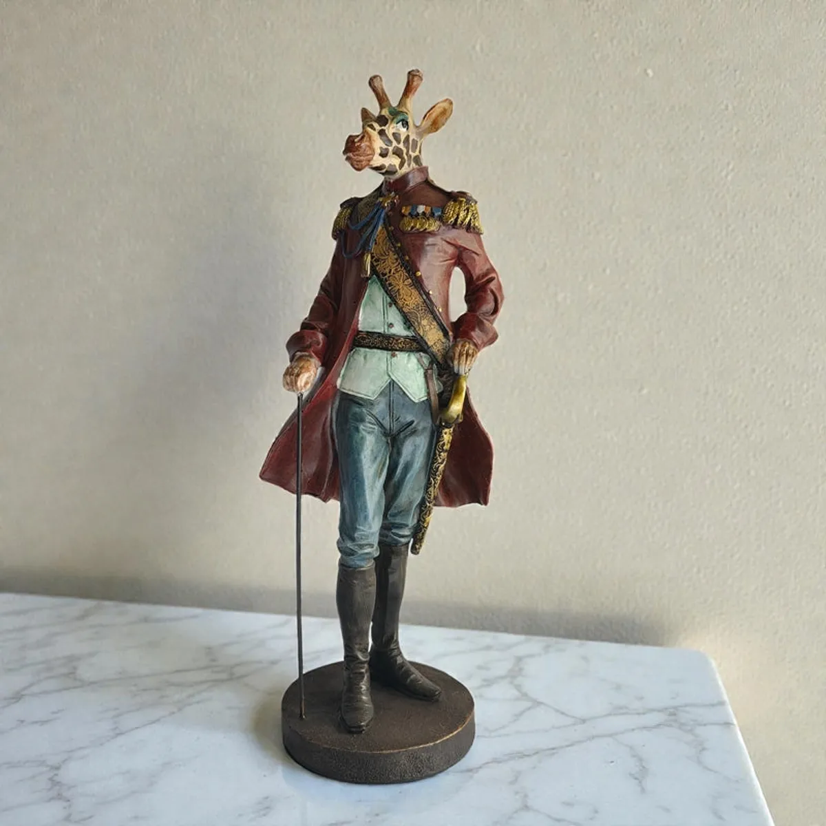 Front view of the figurine on a marble surface against a plain wall.