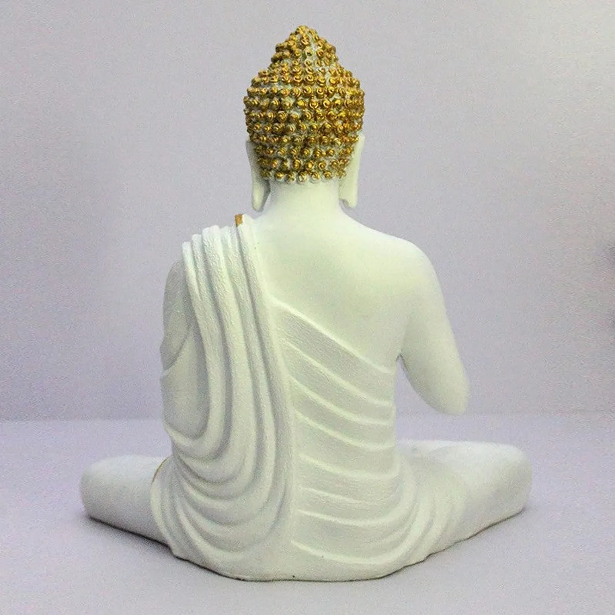 Back view of white Buddha showpiece with gold textured hair detail
