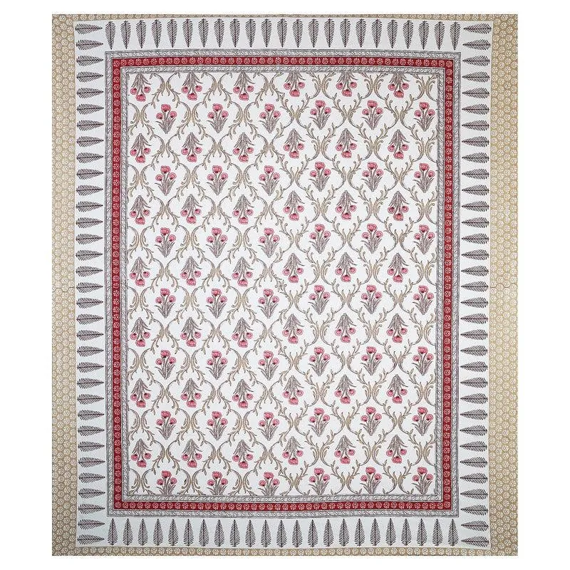 Flat lay of red and white floral bedsheet with detailed ethnic border
