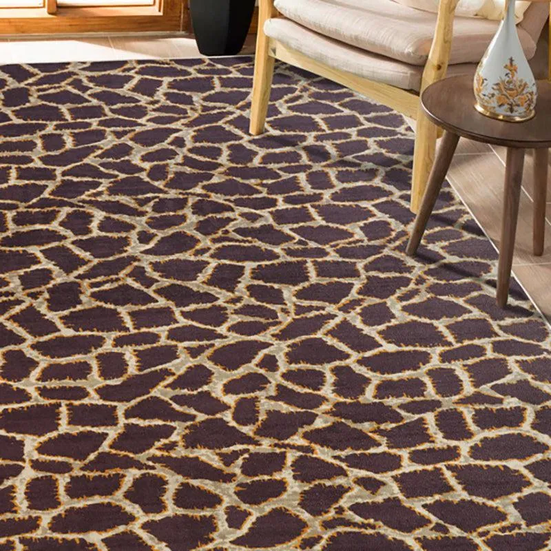 Brown and beige abstract rectangular carpet styled beside a chair and side table