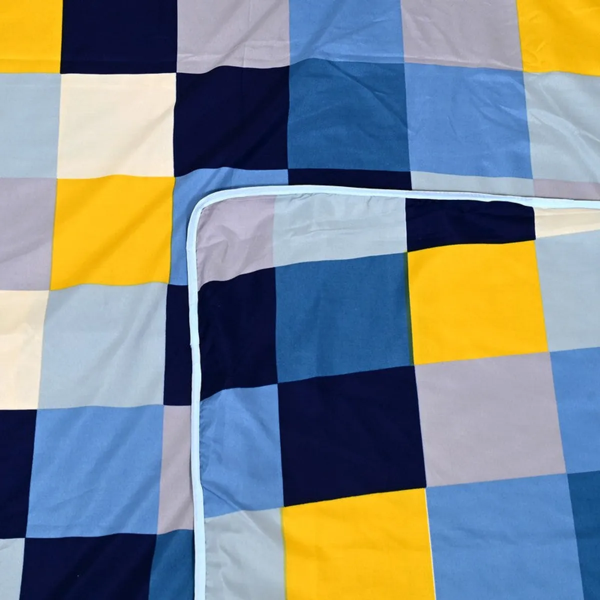 Close-up showing the checked dohar fabric and pale blue edging