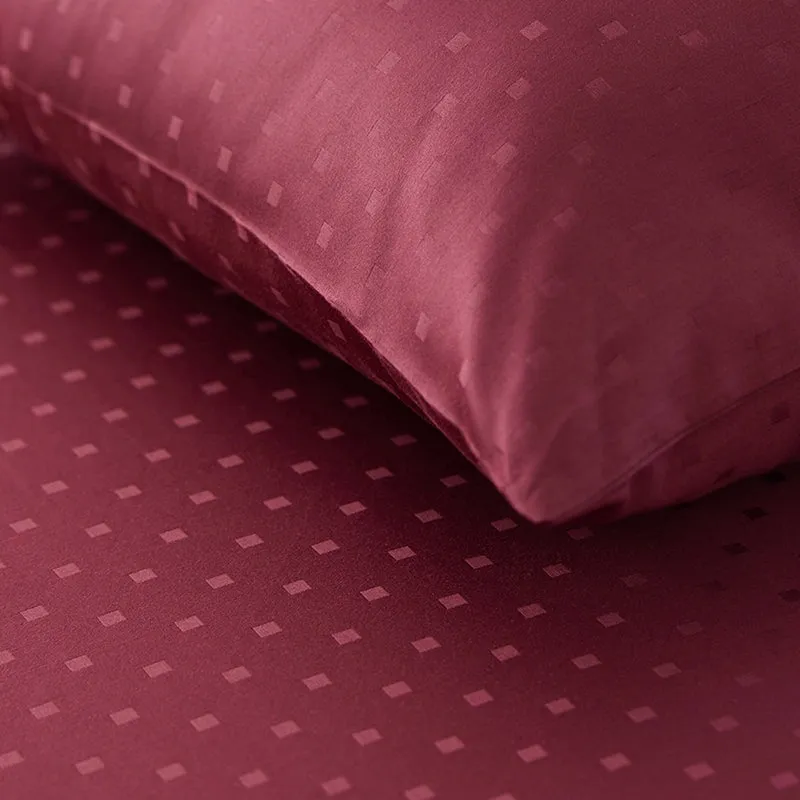 Close-up of the duvet cover's subtle geometric square pattern