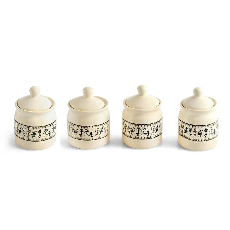 Four matching off-white ceramic jars with lids arranged in a row.