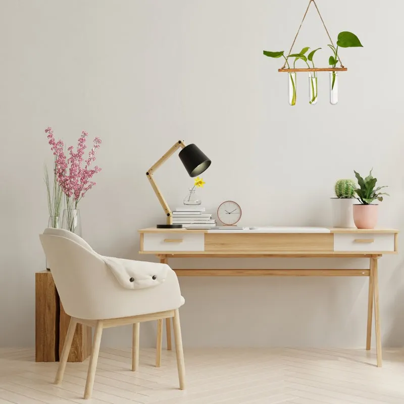 Hanging three-tube planter displayed above a light wood desk in a minimalist room