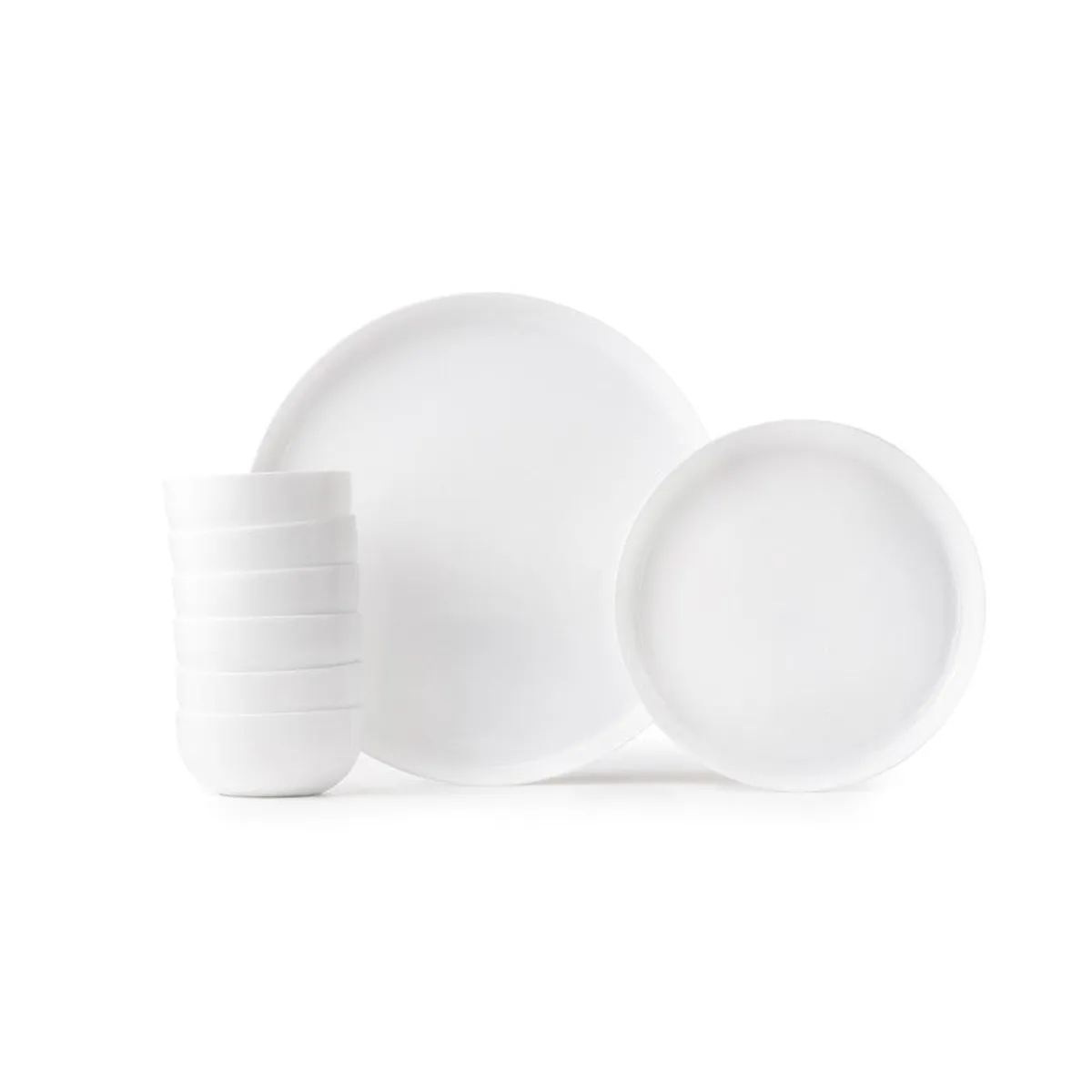 White dinner plates and bowls arranged against a plain background