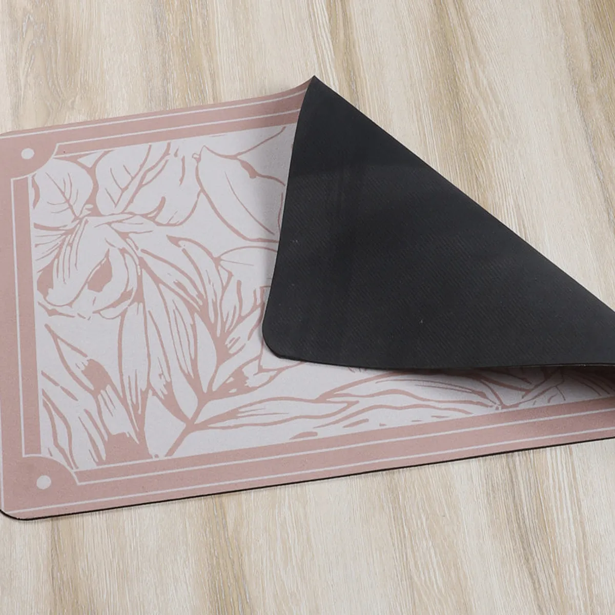 Bath mat corner lifted to show its black anti-skid underside.