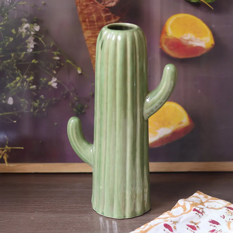 Dark green ceramic cactus-shaped vase styled on a tabletop