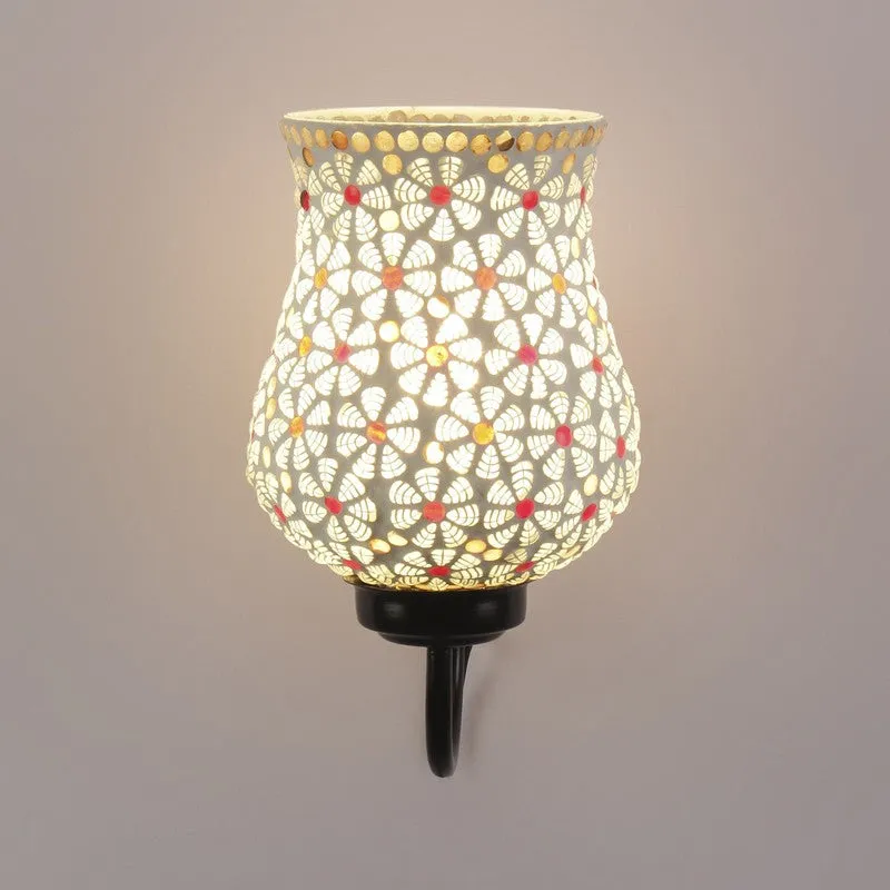 Front view of lit white bell-shaped mosaic glass wall lamp