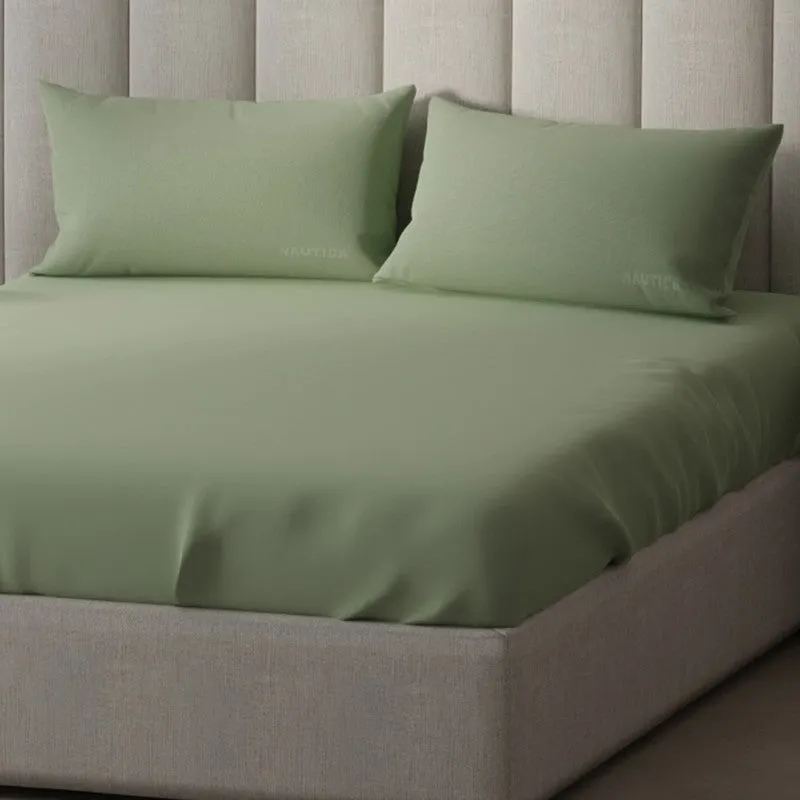 Close-up of olive green satin cotton bedsheet with matching pillows