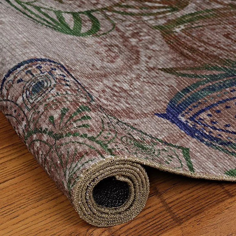 Rolled edge of the carpet showing its thin flat weave profile