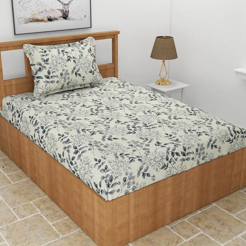 Single bed styled with grey floral fitted bedsheet and matching pillow cover