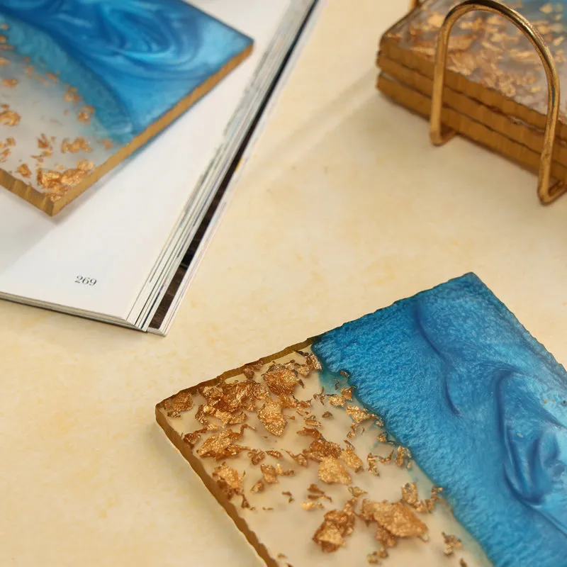Close-up of a blue and gold square resin coaster