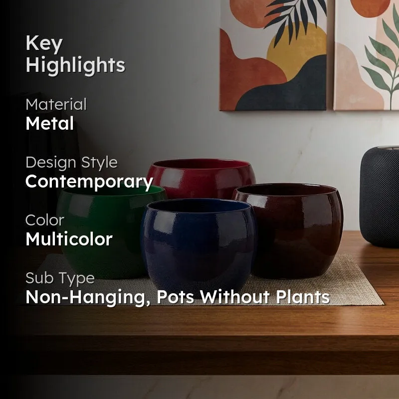 Lifestyle view of four colourful contemporary planters in a living room.