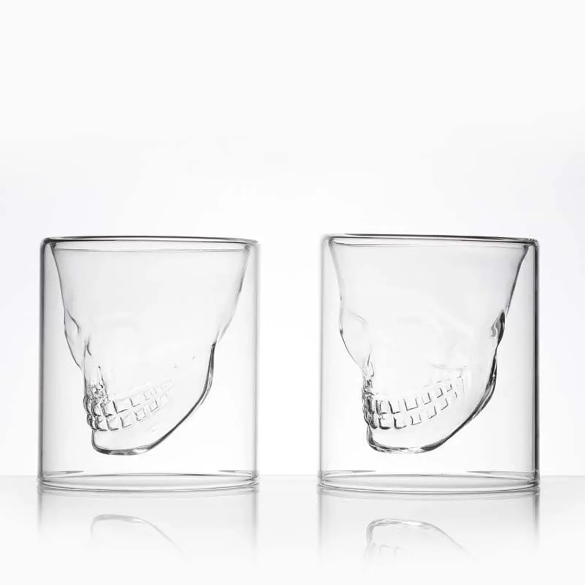 Two transparent skull-design shot glasses shown from an angled view.