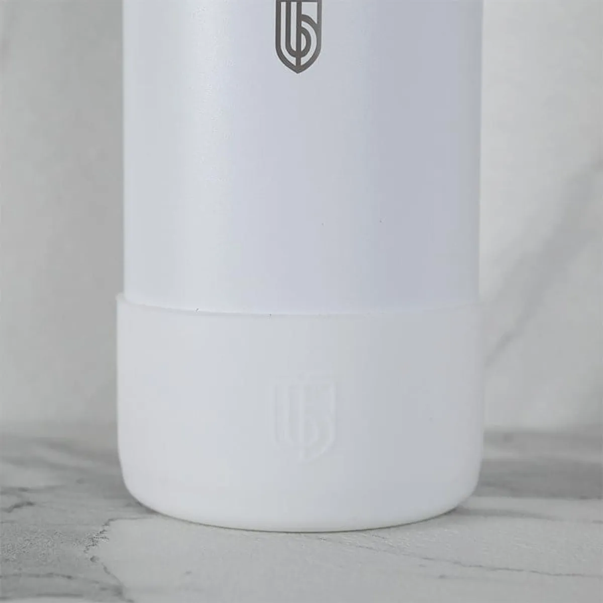 White and sky-blue insulated bottle set shown together on a marble-effect surface