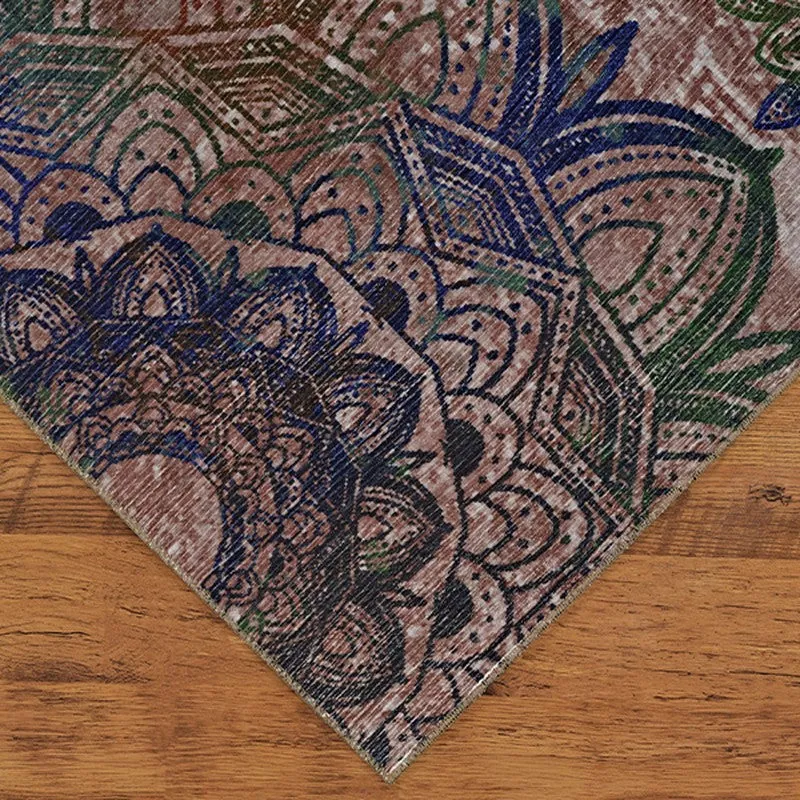 Corner close-up of the carpet showing blue and green ethnic motifs