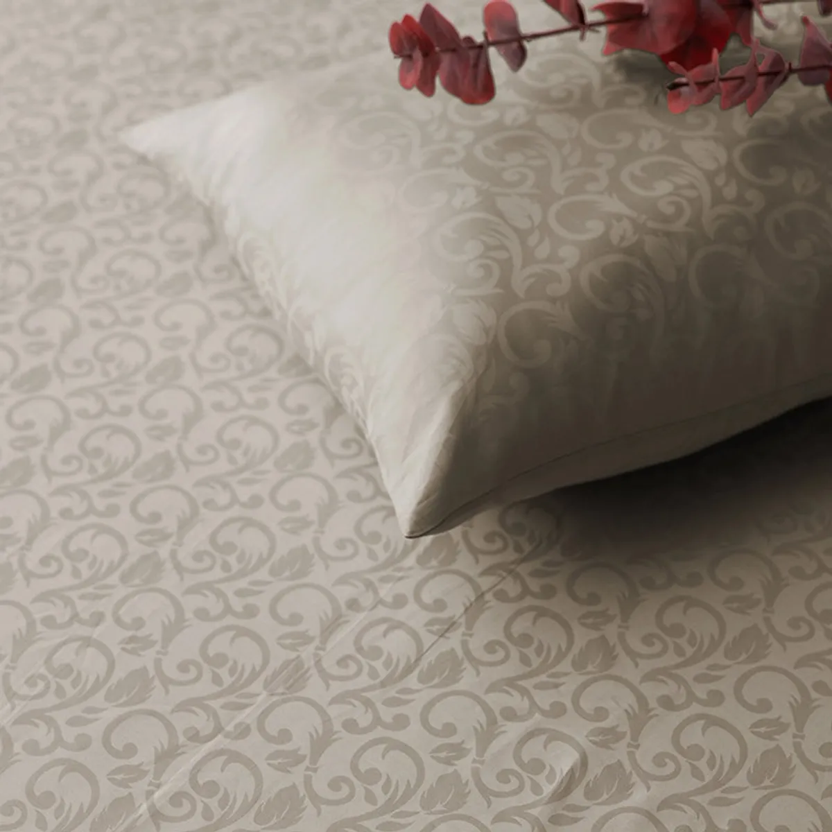 Close-up of beige floral jacquard bedsheet with a matching pillow