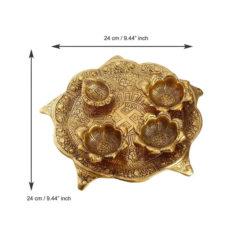 Gold pooja thali shown from above with decorative embossed pattern