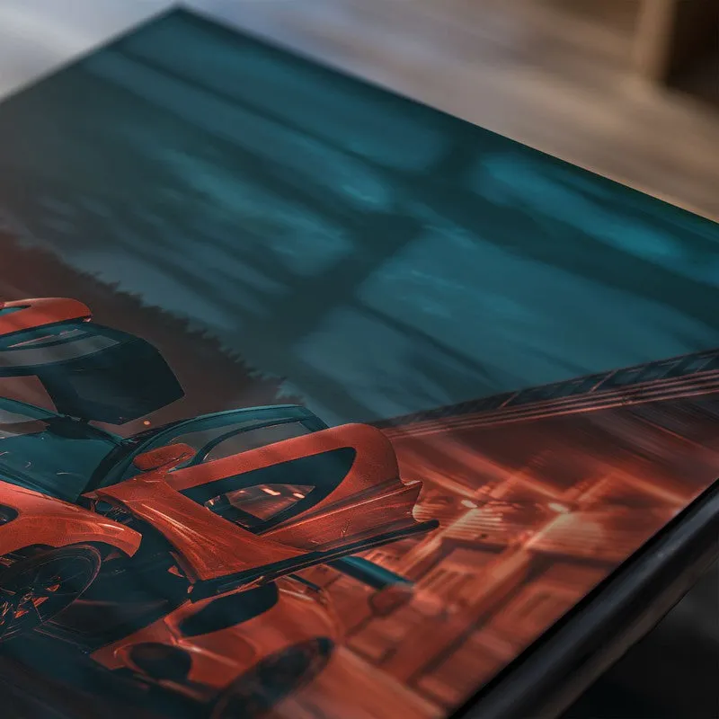 Close-up of car poster with orange sports car against a teal backdrop