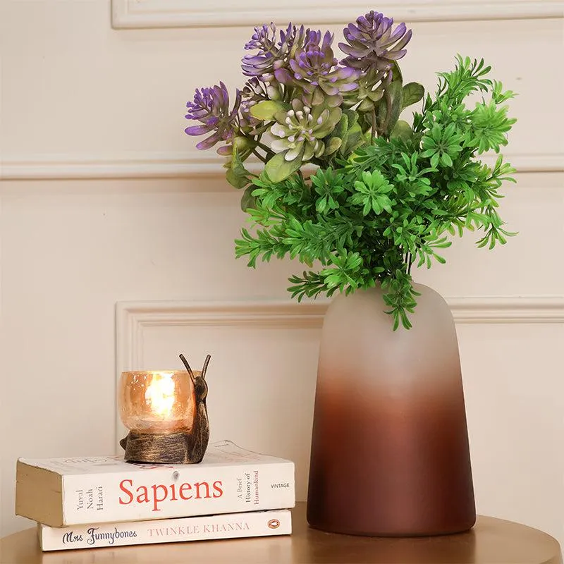Brown frosted ombre glass vase styled with faux stems beside books and a candle