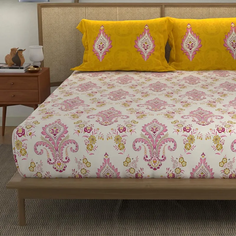 Close view of the pink ethnic motif bedsheet with yellow printed pillow covers