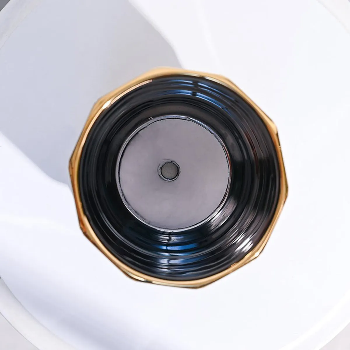 Top view showing the glossy dark interior and gold-edged planter rim.