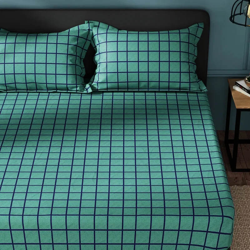 Close view of green and blue checked bedsheet on a bed
