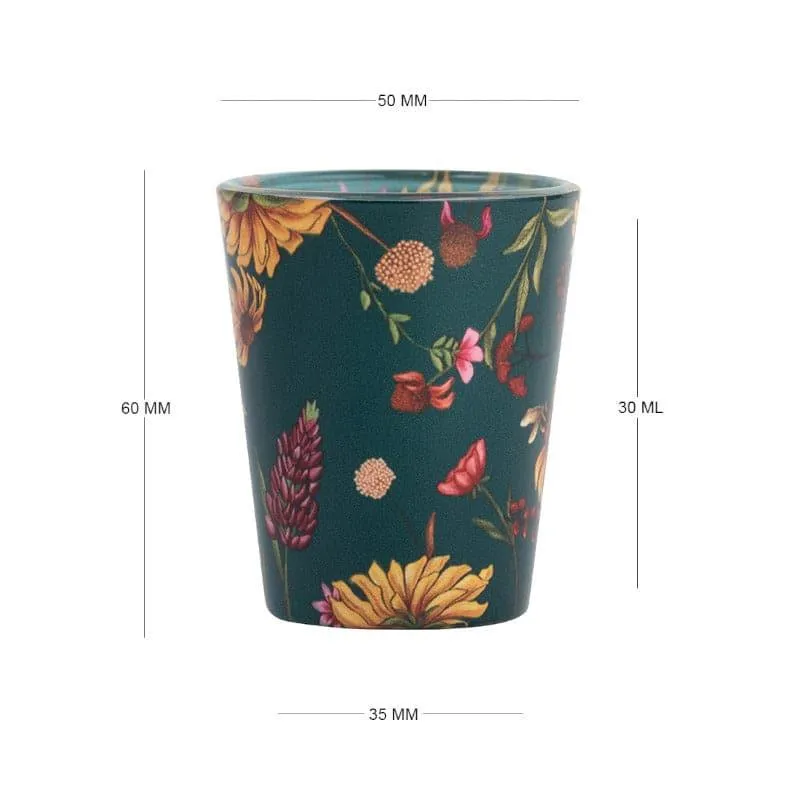 Single green floral shot glass with botanical print on a white background