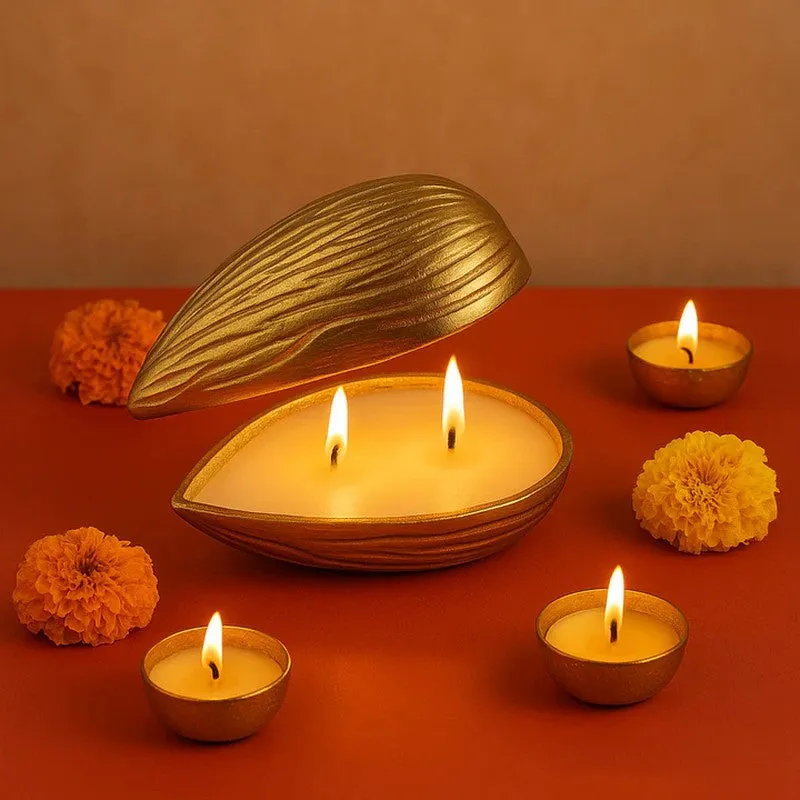 Open golden almond-shaped candle with rose-coloured floral décor