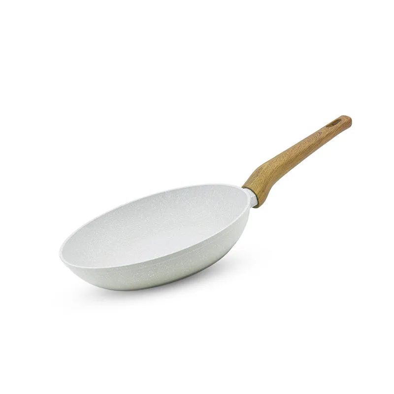 White speckled frying pan with a single brown handle on a plain background