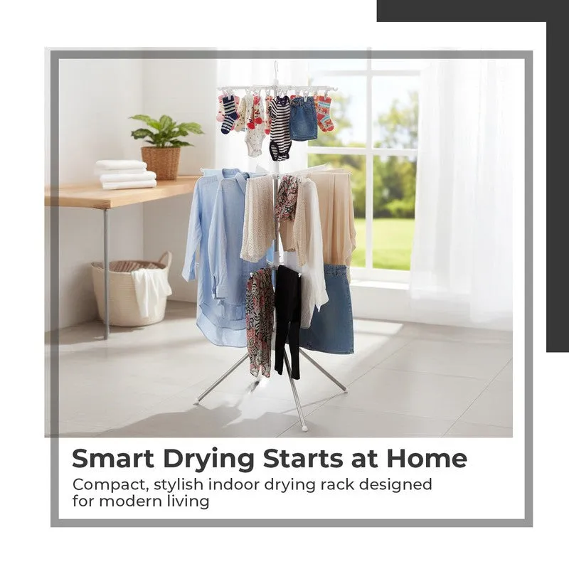 Multi-tier drying rack holding clothes near a sunny window in a laundry space